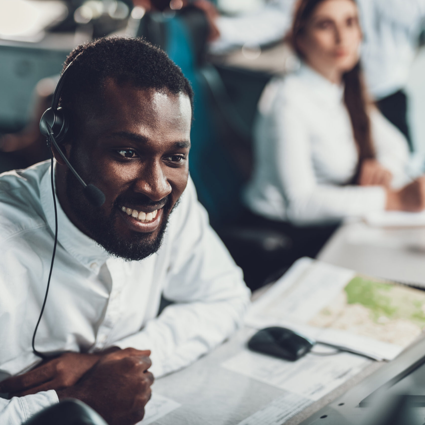 Center of dispatching maintenance. Close up portrait of smiling afro-american operator man monitoring flight data on navigation controller board